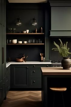 a kitchen with dark green cabinets and wooden counters