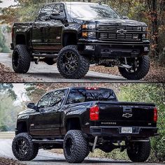 the black truck is parked on the side of the road in front of some trees