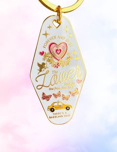 a gold keychain with an image of a car and the words love on it