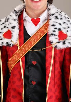 a man wearing a red and black costume with hearts on it's chest is smiling at the camera