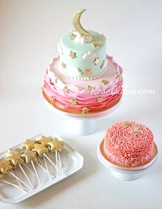 there are three cakes on the table and one is decorated with stars, moon, and crescent