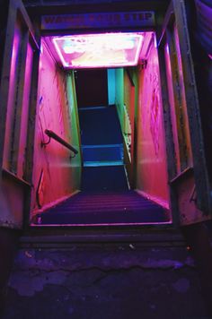 the stairs are lit up with neon lights and there is no one going down them