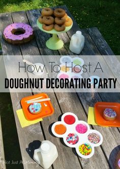 an outdoor picnic table with doughnuts and other party foods on it, including donuts