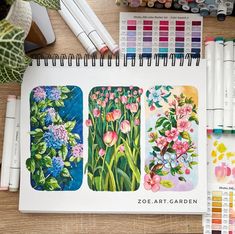 an open notebook with four different colored flowers on it and some crayons next to it