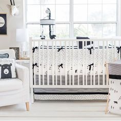 a baby crib with black and white decor