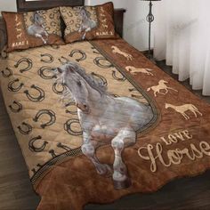 a bed covered in brown and white horses on it's cover with the words, i love horses