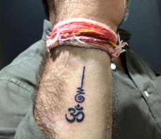 a man with a tattoo on his arm that has the word om written in it