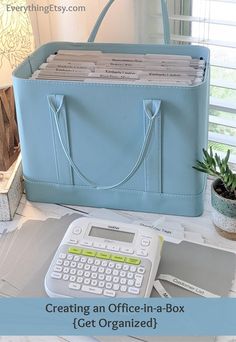 a blue bag sitting on top of a desk next to a calculator