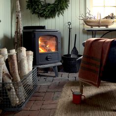 a living room filled with furniture and a fire place next to a christmas wreath on the wall