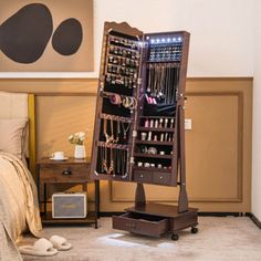 a jewelry rack in the corner of a bedroom