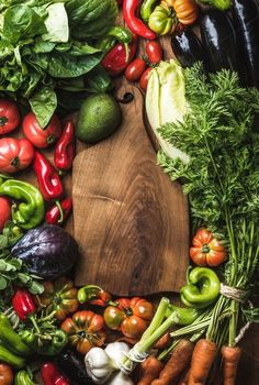 many different types of vegetables are arranged on a cutting board and laid out in the shape of a rectangle