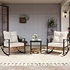 two rocking chairs and a table in front of a window with potted plants on it