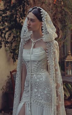 a woman in a white wedding dress and veil