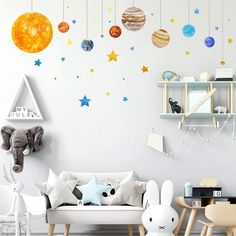 a living room filled with furniture and lots of space wall decals on the walls