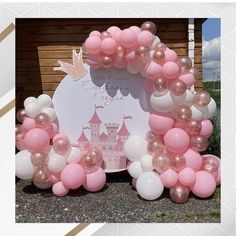 pink and white balloon arch with castle on it