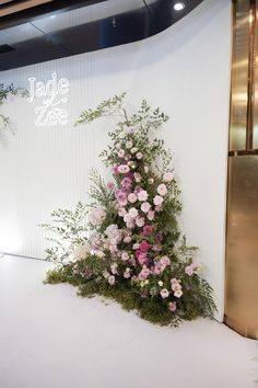 a floral display in front of a white wall