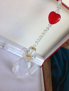 "The perfect gift! A crystal rosary with red hearts and matching SWAROVSKI crystal Sun catcher, ! The rosary: 10mm round cut crystals and 10mm diamond cut crystals from Egypt , measures 21\" long. Red hearts representing the oh fathers. ANGEL: 2.25\" tall for the image . Total length of the sun catcher is 9\" long. With a magnet clasp for really easy on/of around rear view mirror!! Or hanging place of your choice . Please feel free to ask any questions!" Clear Round Beads Crystals As Gifts, Spiritual Rosary As Valentine's Day Gift, Faceted Crystals As Gifts, Faceted Crystal Gift, Faceted White Crystals For Gifts, White Faceted Crystals For Gifts, White Faceted Crystals As Gifts, Spiritual Faceted Beads Crystals As Gift, White Faceted Beads Crystals For Gift