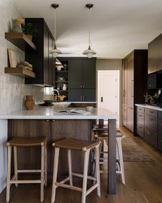 two stools sit at the center of a kitchen island