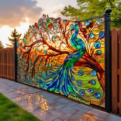 a colorful peacock painted on the side of a fence