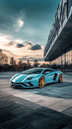 a blue sports car parked in front of a building