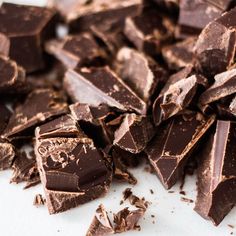 a pile of chocolate pieces sitting on top of a white table