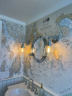 a bathroom with a map on the wall next to a sink and faucet