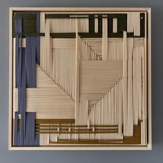 an art piece made out of wood with different colored strips on the bottom and sides