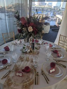 a table set with place settings and flowers