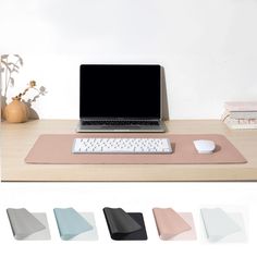 a laptop computer sitting on top of a desk next to a mouse pad and keyboard