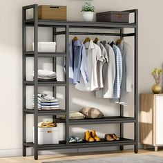 an organized closet with clothes, shoes and boxes on the shelves in front of it