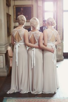 the bridesmaids are looking at each other in their wedding gowns and dresses