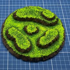 there is a cake made to look like the letter s on top of green grass