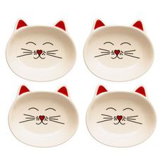 four white cat bowls with red ears and eyes on them, one has a heart in its mouth