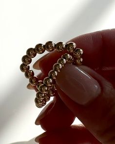 This stunning round beaded ring, made with highly polished gold-filled beads, is a perfect accessory for any look. The comfy elastic band ensures strong but gentle support as you stack this golden ring with other jewelry to show off your unique style. simply delightful! • Available in sterling silver, gold filled.• Round beads on a stretch cord• Bead size options : 3mm ,4mm, and 5mm Rose Gold 14k Gold-filled Round Beads Jewelry, Elegant Beaded Promise Ring, Rose Gold Jewelry With Gold Beads, Stackable Rose Gold Beaded Bracelets, Dainty Jewelry With 8mm Round Beads, Rose Gold Stackable Beaded Bracelets, Rose Gold Beaded Bracelet With 14k Gold, Dainty Round 8mm Bead Jewelry, Rose Gold 14k Gold Beaded Bracelets