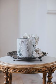 a white cake sitting on top of a wooden table