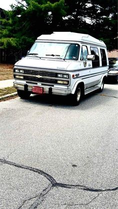 an old van is parked on the side of the road