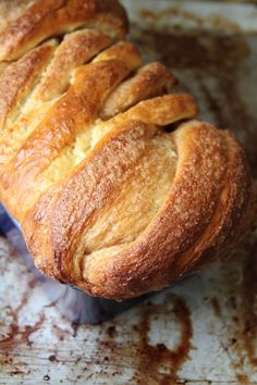 a loaf of bread sitting on top of a metal pan