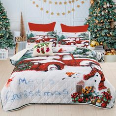 a bed with christmas decorations on it in front of a christmas tree