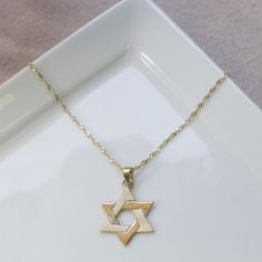 "Dainty 14k Solid Yellow Gold Star of David pendant necklace, delicate Jewish fine jewelry for women and men, handmade by AditaGold. This beautiful handmade necklace is made of 14K solid yellow gold and has a gorgeous Star of David (Magen David) pendant. This necklace is dainty, but very noticeable. It can be a wonderful Bat Mitzvah or birthday gift. This necklace is light and will compliment every look, and for every occasion.  This handmade gold necklace is carefully handcrafted at my workshop 14k Gold Star Of David Necklace Engraved, 14k Gold Star Of David Necklace For Anniversary, Gold Star Of David Necklace For Anniversary, 14k Gold Star Of David Necklace Gift, Gift 14k Gold Star Of David Necklace, Handmade Gold Necklace, Jewish Necklace, Star Of David Necklace, Bat Mitzvah Gifts