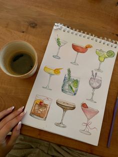 a drawing of various cocktails and drinks on a table next to a cup of coffee