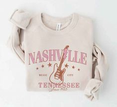 Nashville is where it's at! This trendy graphic sweatshirt is so cute with its Nashville Destination, and featuring a guitar! After all it is music city right? You’ll be comfy in its unisex oversized fit, and soft inner lining! Oversized Casual Sweatshirt For Concerts, Fall Concert Sweatshirt With Letter Print, Letter Print Sweatshirt For Concerts In Fall, Letter Print Sweatshirt For Fall Concerts, Urban Style Sweatshirt For Fall Concert, Urban Style Sweatshirt For Concert In Fall, Casual Letter Print Sweatshirt For Concert, Casual Cotton Sweatshirt For Concerts, Trendy Relaxed Fit Sweatshirt For Concert