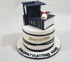 a graduation cake with a book and mortar on top