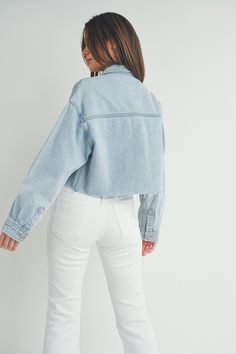 This cargo inspired denim jacket by Just Black is the perfect addition to your wardrobe. Made from lightweight cotton denim, this trendy jacket features an oversized boxy fit + a cropped length with raw hem detail. The large cargo chest pockets are right on trend + add a casual touch to this jacket. This will be an easy layering piece to throw on + go all season long. Fit: Oversized, boxy cut. Fabric: 100% Cotton Black Cargo Jacket, Maxi Jumpsuit, Kimono Sweater, Trendy Jackets, Cargo Jacket, Cropped Denim Jacket, Cropped Denim, Dress With Cardigan, Light Denim