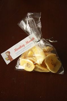 a bag filled with sliced bananas sitting on top of a wooden table next to a label