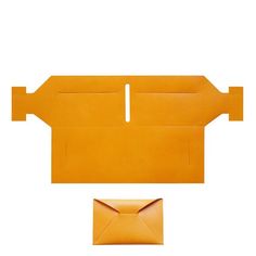 an orange envelope is opened and sitting next to it's cardboard base on a white background