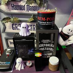 various items are displayed on a table in front of halloween signs and other decorative items