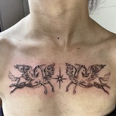 a woman's chest with two angels and a star tattoo on her left side