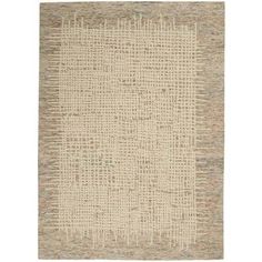 an area rug with different colors and patterns on the floor, including beiges and browns