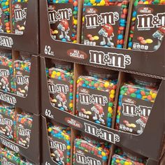 many boxes of m & m's are stacked on each other