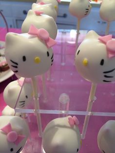 hello kitty lollipops on sticks with pink bows are ready to be eaten